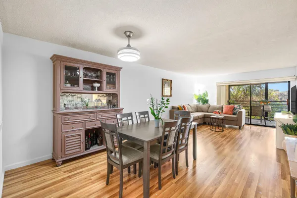 a living room with furniture and floor to ceiling windows