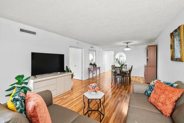 a living room with furniture and wooden floor