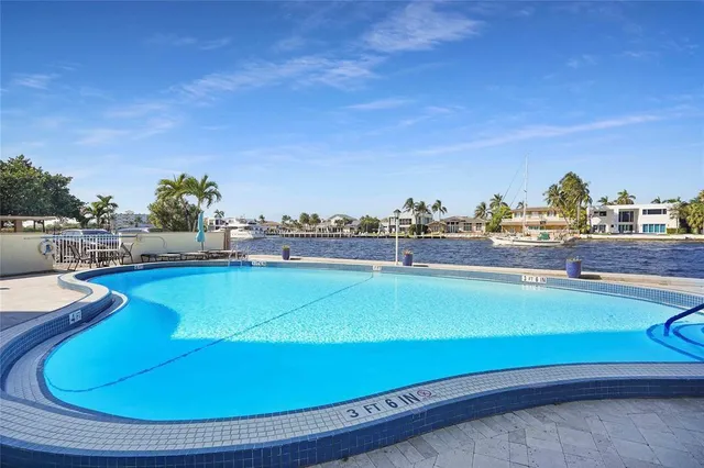 a view of a swimming pool with sitting area