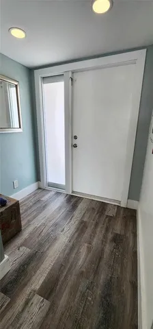 a view of hallway with wooden floor