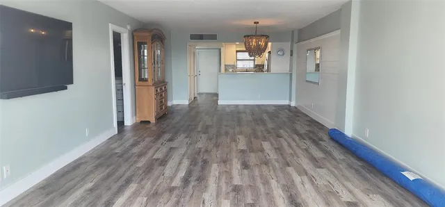 a room with wooden floor and cabinets