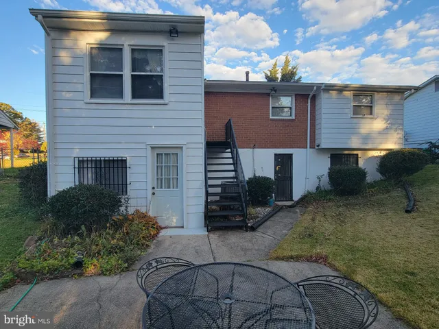 a view of a house with a yard and sitting space