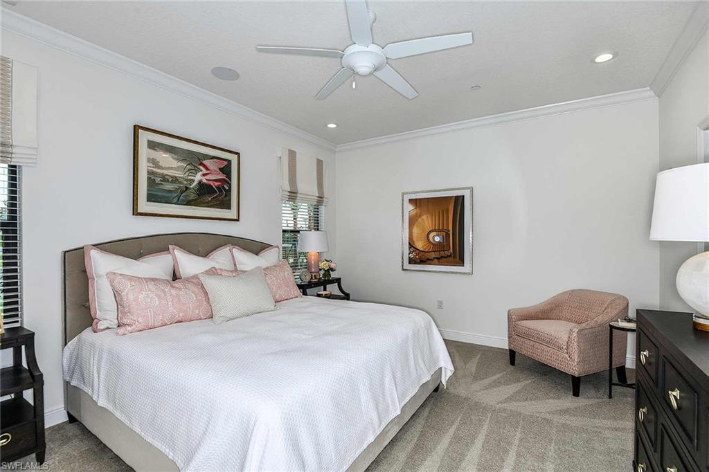 4637 Centaurus Circle Naples, FL 34120 - Photo 14 of 40 a bedroom with bed and a chandelier