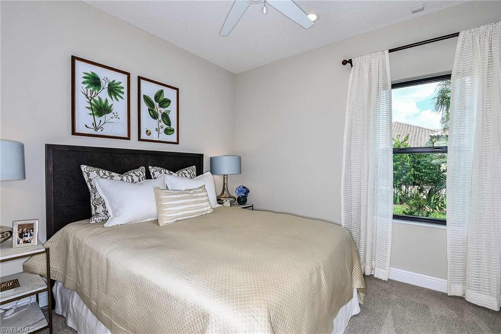 4637 Centaurus Circle Naples, FL 34120 - Photo 21 of 40 a large bed sitting in a bedroom next to a window
