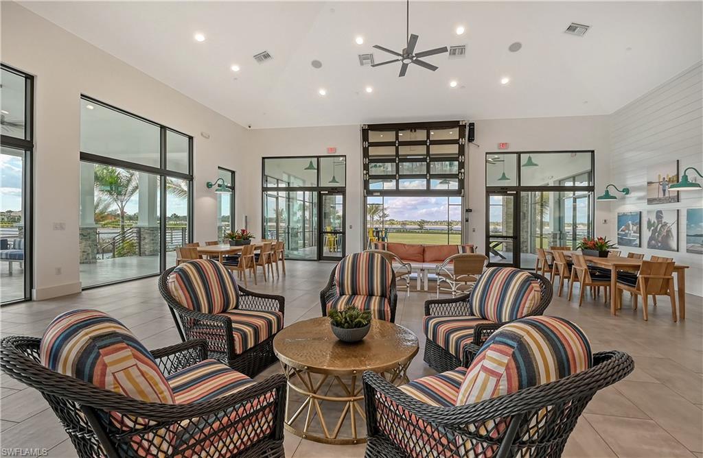 4637 Centaurus Circle Naples, FL 34120 - Photo 35 of 40 a living room with furniture and a floor to ceiling window