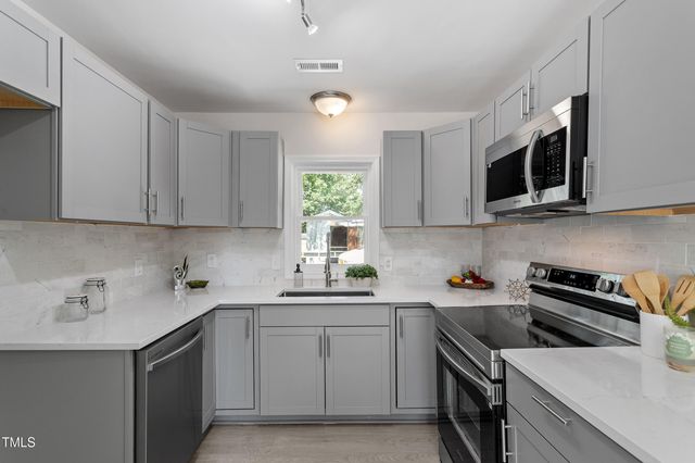 a kitchen with a sink stove and microwave