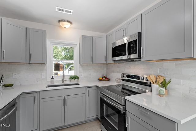 a kitchen with a sink stove and microwave