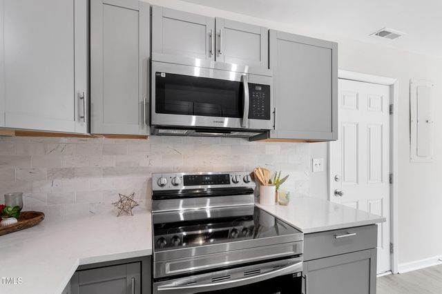 a kitchen with a stove and a microwave