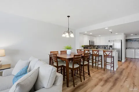 a dining room with furniture wooden floor and a chandelier