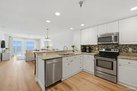 a kitchen with a sink stove and microwave