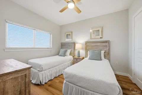 a bedroom with two beds and a flat screen tv