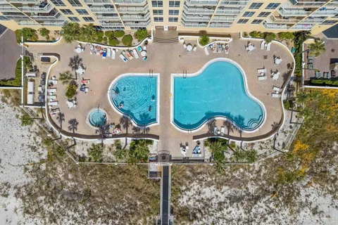 a view of a swimming pool with outdoor seating