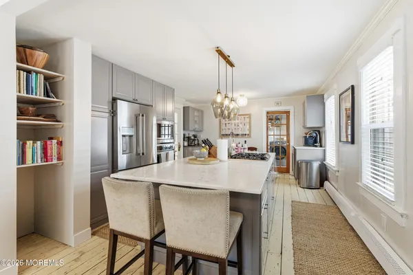a kitchen with stainless steel appliances a stove top oven and a refrigerator