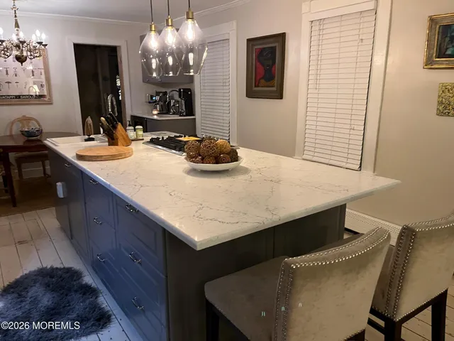 a kitchen with a sink a table and chairs in it