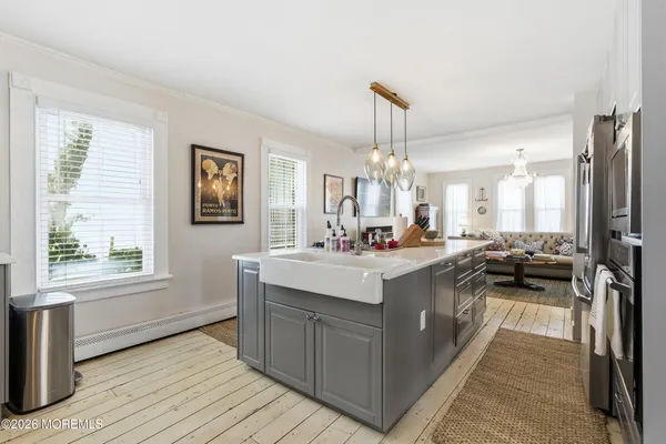 a view of a dining room with furniture and chandelier
