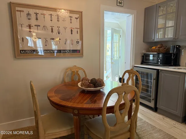 a view of a dining room with furniture and chandelier