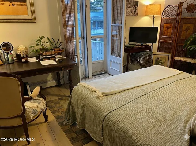 a bedroom with a bed and flat screen tv