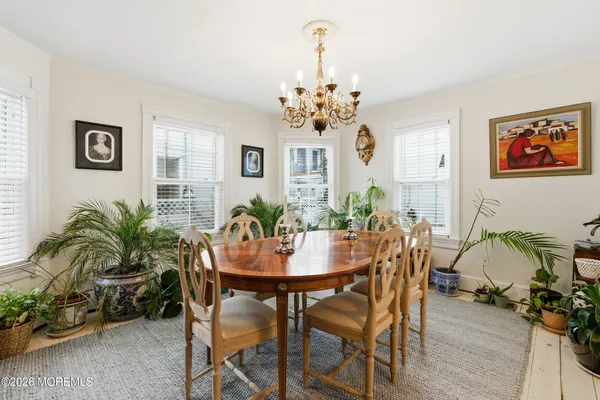 a hallway with painting and a book shelf