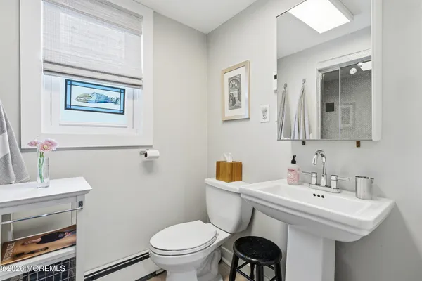 a bathroom with a shower a toilet and a sink