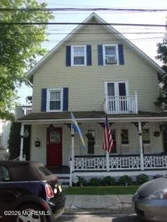 a front view of a house with lots of green space