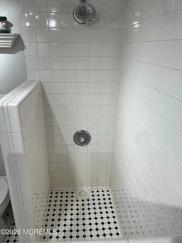 a bed room with a bed mirror and a window