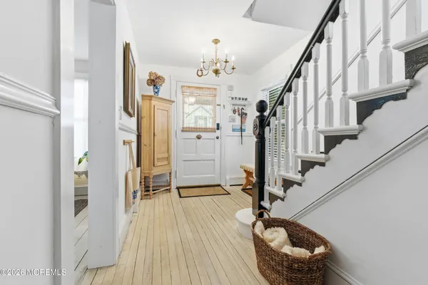 a view of a dining room with furniture and a chandelier
