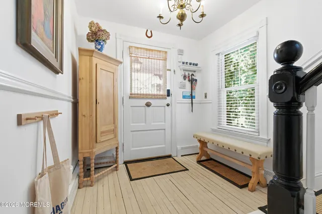a kitchen with a stove and a wooden floor
