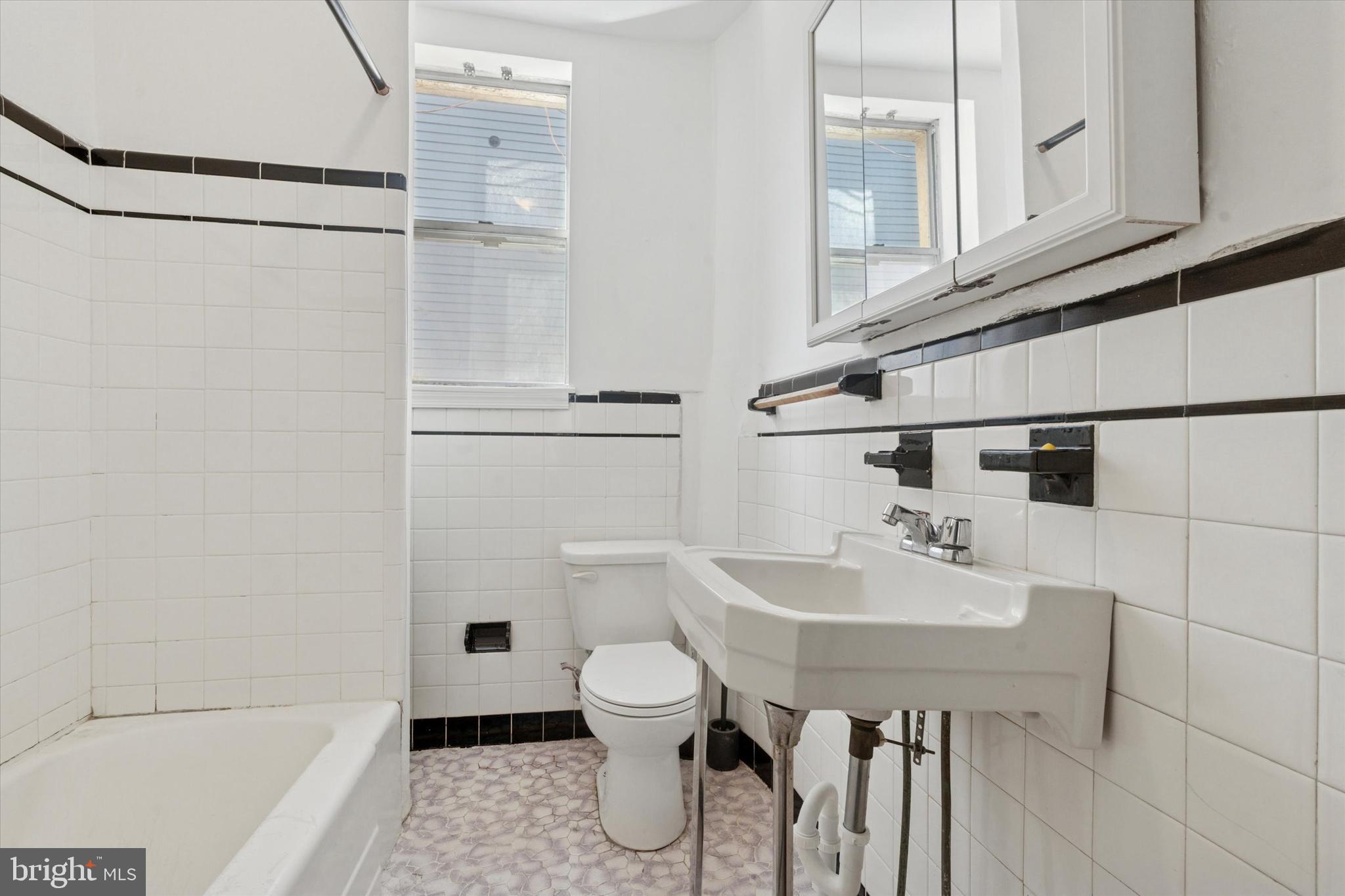 1710 South 10th Street, Unit 2 Philadelphia, PA 19148 - Photo 13 of 15 a bathroom with a sink a toilet and shower
