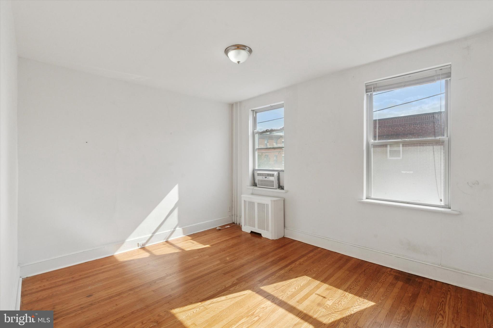 1710 South 10th Street, Unit 2 Philadelphia, PA 19148 - Photo 6 of 15 a view of empty room with wooden floor and fan