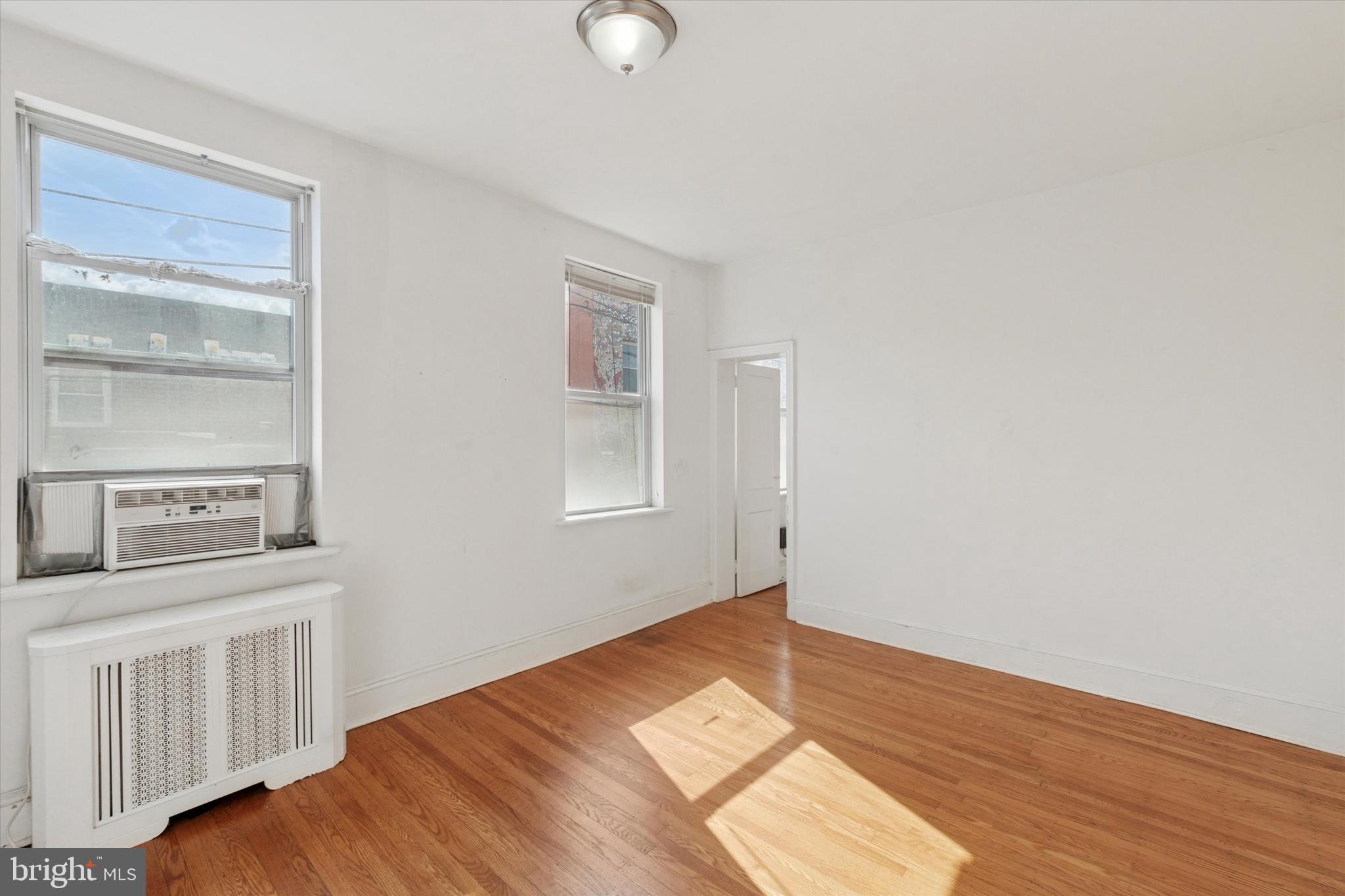 1710 South 10th Street, Unit 2 Philadelphia, PA 19148 - Photo 7 of 15 a view of a bedroom with wooden floor