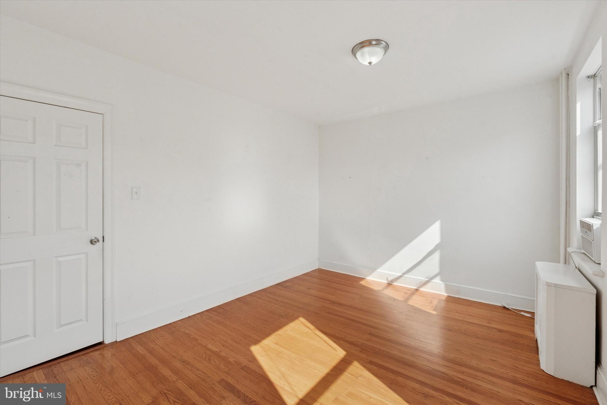 1710 South 10th Street, Unit 2 Philadelphia, PA 19148 - Photo 8 of 15 a view of a room with wooden floor and white walls
