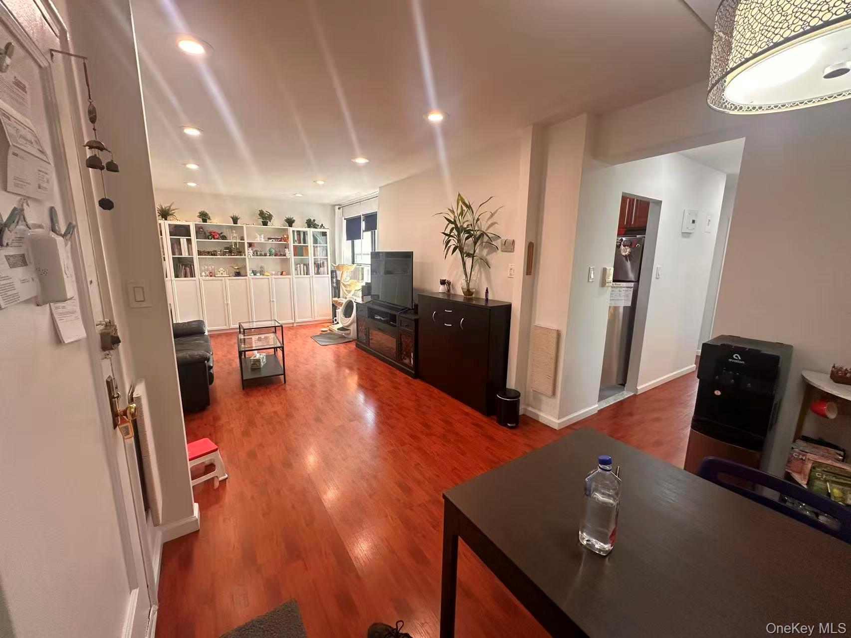 139-15 28th Road, Unit 6G Queens, NY 11354 - Photo 8 of 20 a view of a living room with furniture and a wooden floor