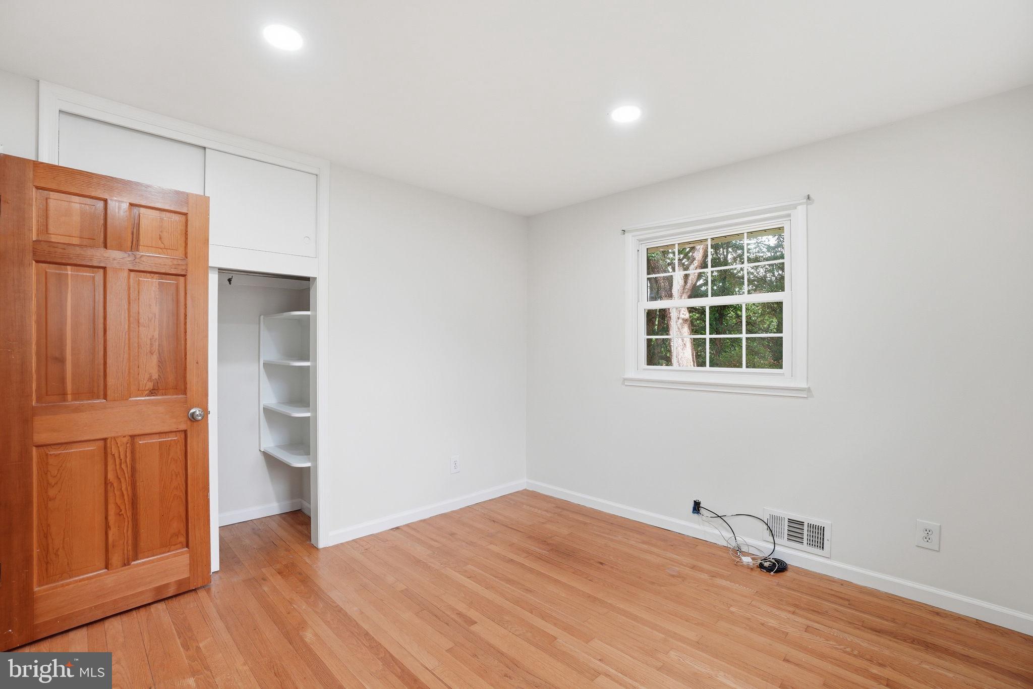 5304 Pillow Lane Springfield, VA 22151 - Photo 15 of 32 an empty room with wooden floor and windows