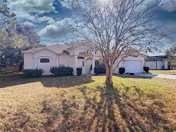 a view of a house with a yard covered with snow