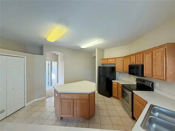 a kitchen with stainless steel appliances a refrigerator and a stove top oven