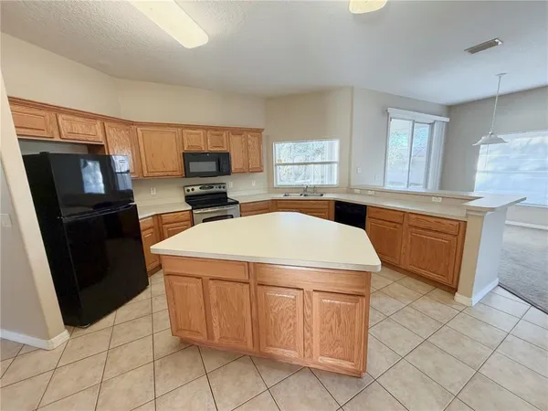 a kitchen with a stove top oven and cabinets