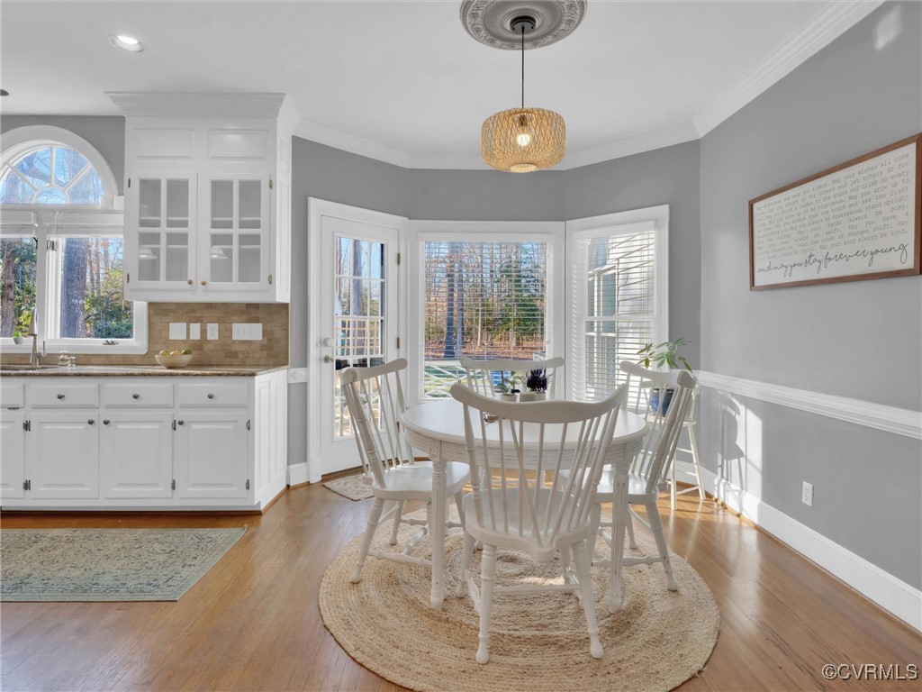 5304 Clipper Cove Road Midlothian, VA 23112 - Photo 19 of 50 a view of a dining room with furniture a chandelier and wooden floor