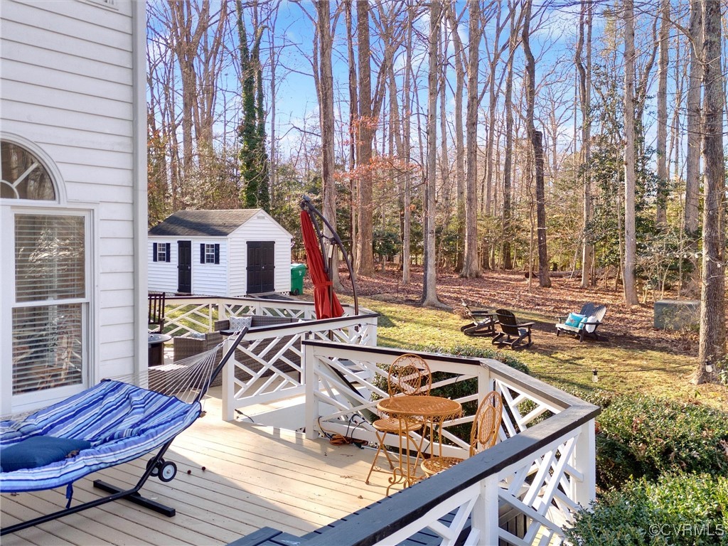 5304 Clipper Cove Road Midlothian, VA 23112 - Photo 42 of 50 a view of a patio with chairs and umbrellas on a deck