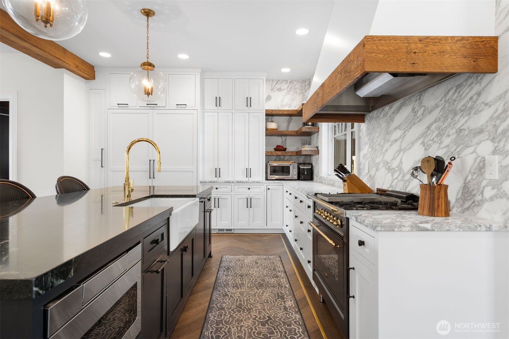 312 Prospect Street Seattle, WA 98109 - Photo 13 of 40 a kitchen with stainless steel appliances granite countertop a stove a sink and a refrigerator