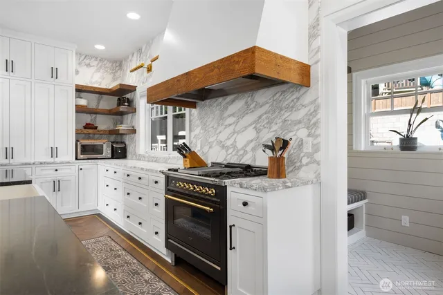 a kitchen with stainless steel appliances a stove a sink and a refrigerator