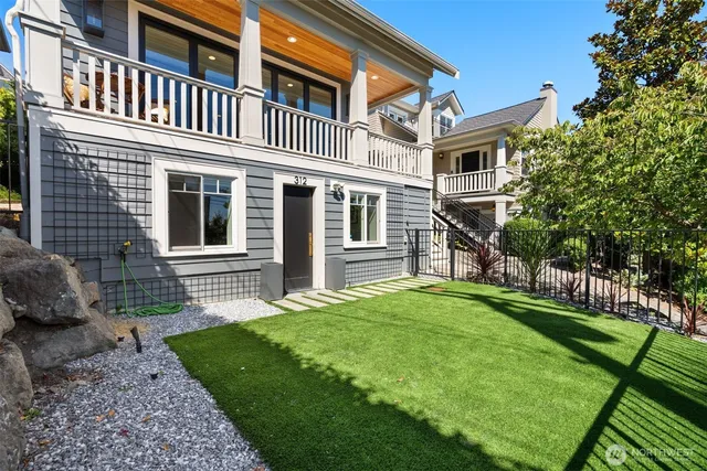 a view of a house with a yard and sitting area