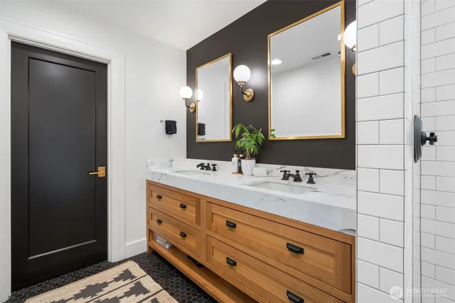 a bathroom with a double vanity sink and a mirror