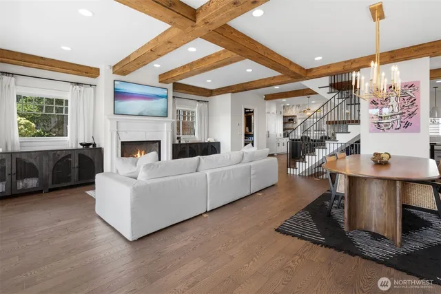 a living room with furniture large window and a fireplace