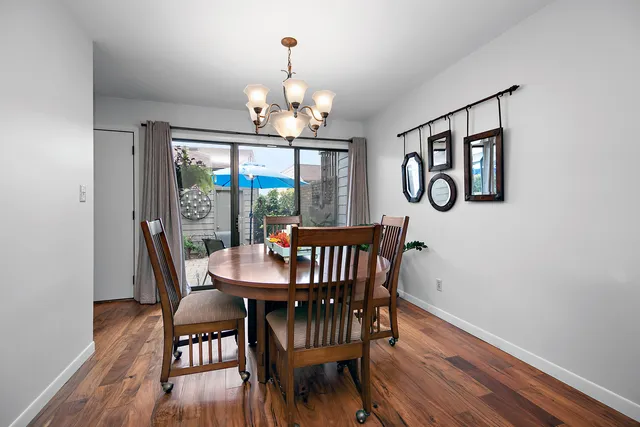 a view of a dining room with furniture wooden floor and chandelier