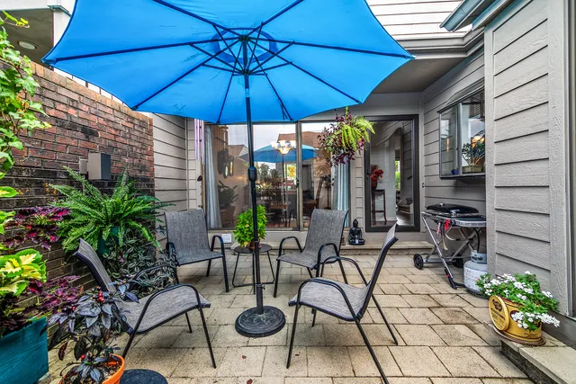 a patio with a patio table and chairs