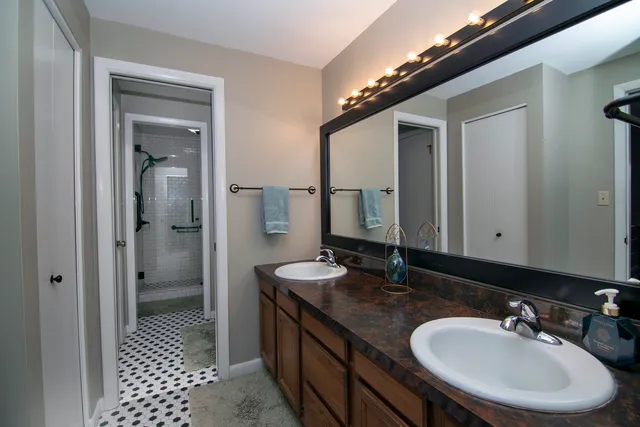 a bathroom with a granite countertop sink and a mirror