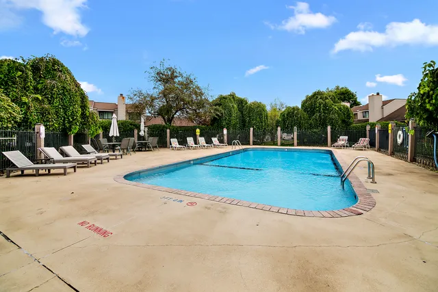 a view of a swimming pool with an outdoor space and seating area