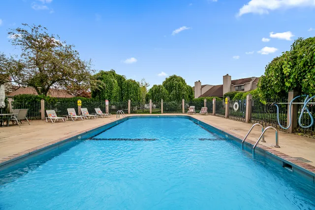 a swimming pool with outdoor seating and yard