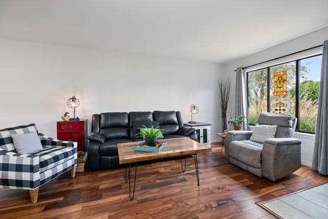 a living room with furniture and a large window