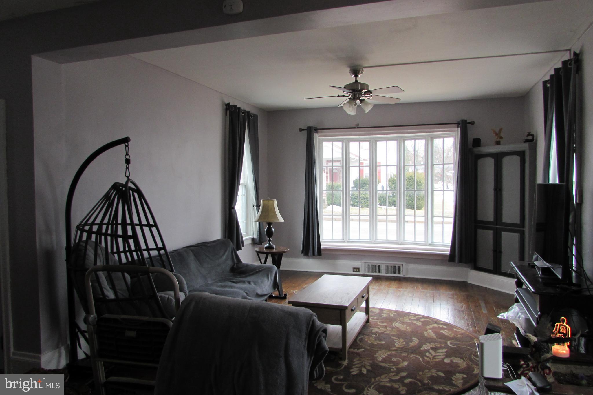412 South Potomac Street Waynesboro, PA 17268 - Photo 7 of 46 a living room with furniture a flat screen tv and a large window